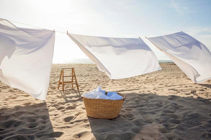 white-sheets-hanging-on-laundry-line-at-beach-siri-stafford